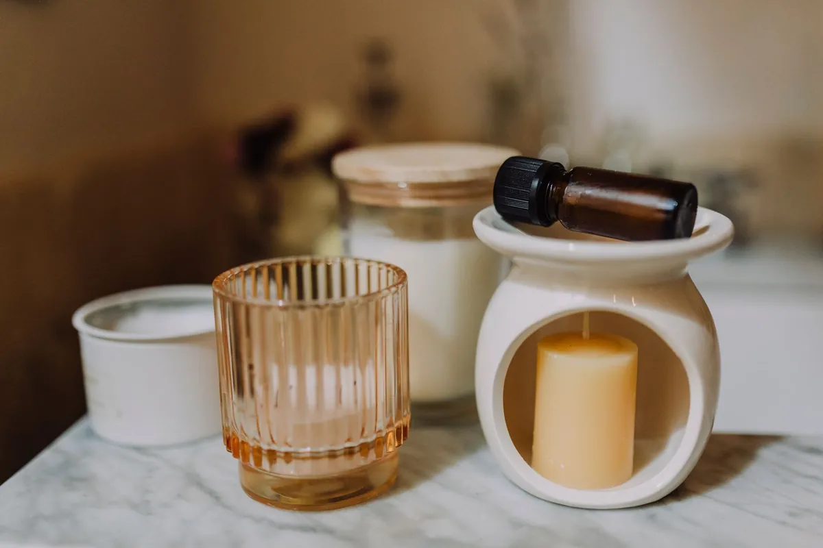 Minimal ceramic and glass candles arranged as a home gift