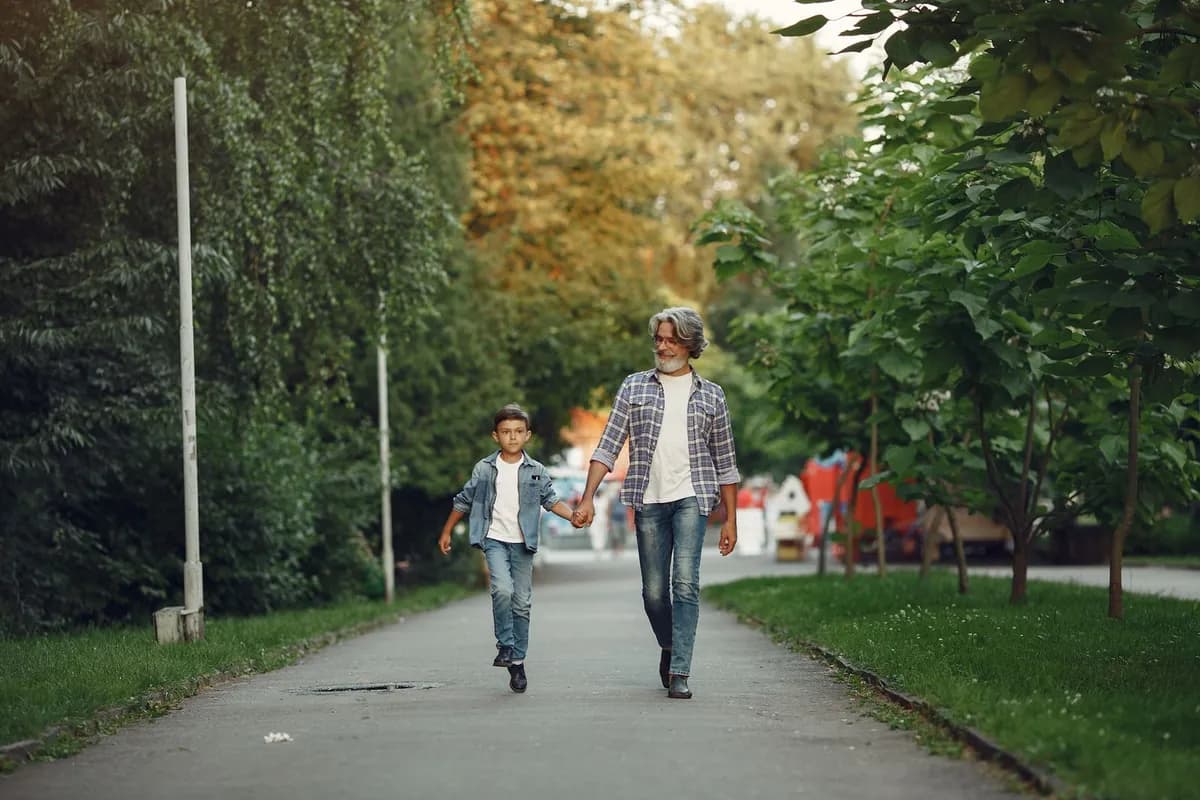 Grandfather and grandson enjoying a relaxed walk together in a park