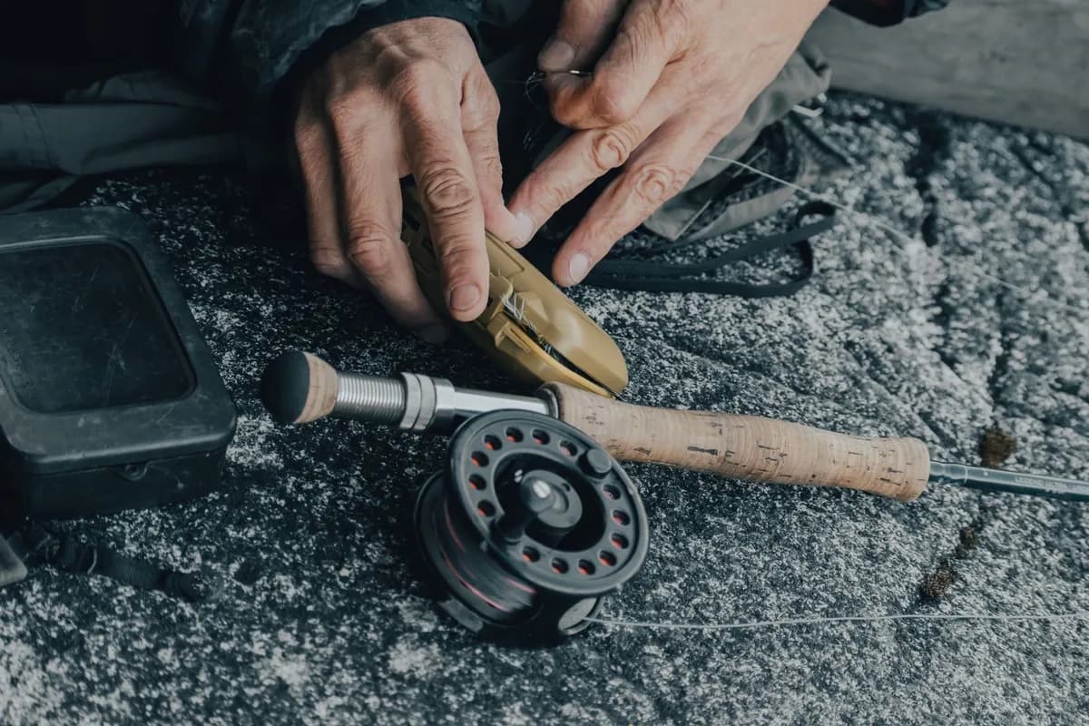 Hands preparing fishing equipment outdoors as an example of hobby gear