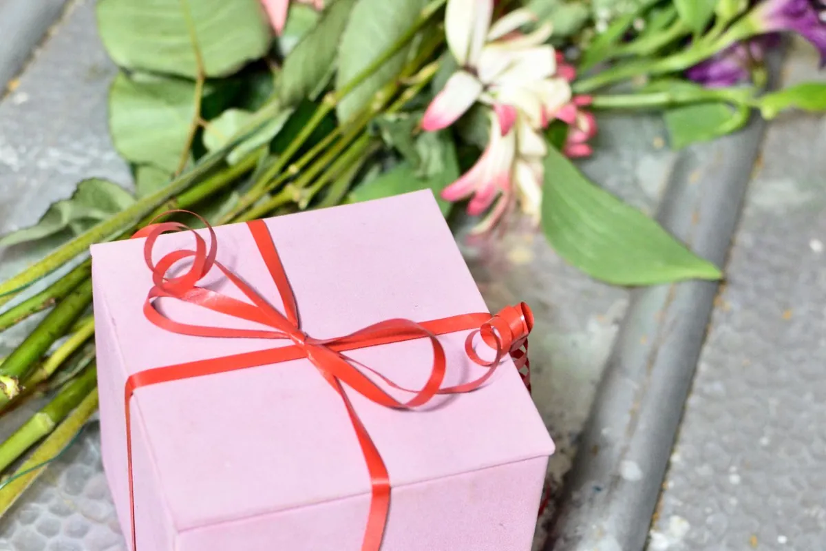 Gift box paired with a soft bouquet of flowers