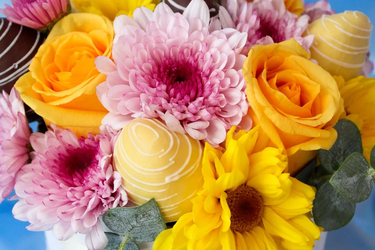 Colorful flower bouquet arranged with chocolate accents